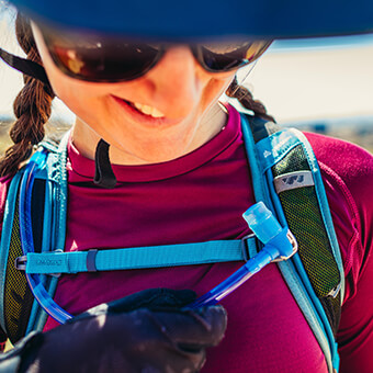 Magnetic sternum strap allows for one handed magnetic buckling of strap and integrated magnetic linkage for the DryLock bite valve