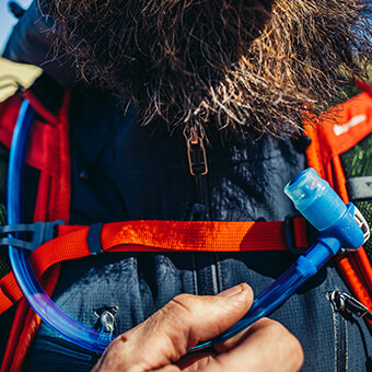 Magnetic sternum strap allows for one handed magnetic buckling of strap and integrated magnetic linkage for the DryLock bite valve