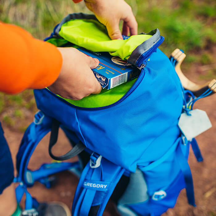 Top pocket with dual pockets to provide a dedicated area for a headlamp or snacks
