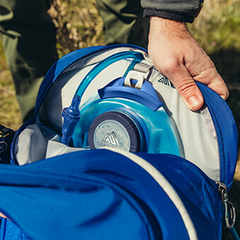Zippered hydration pocket with SpeedClip attachment system